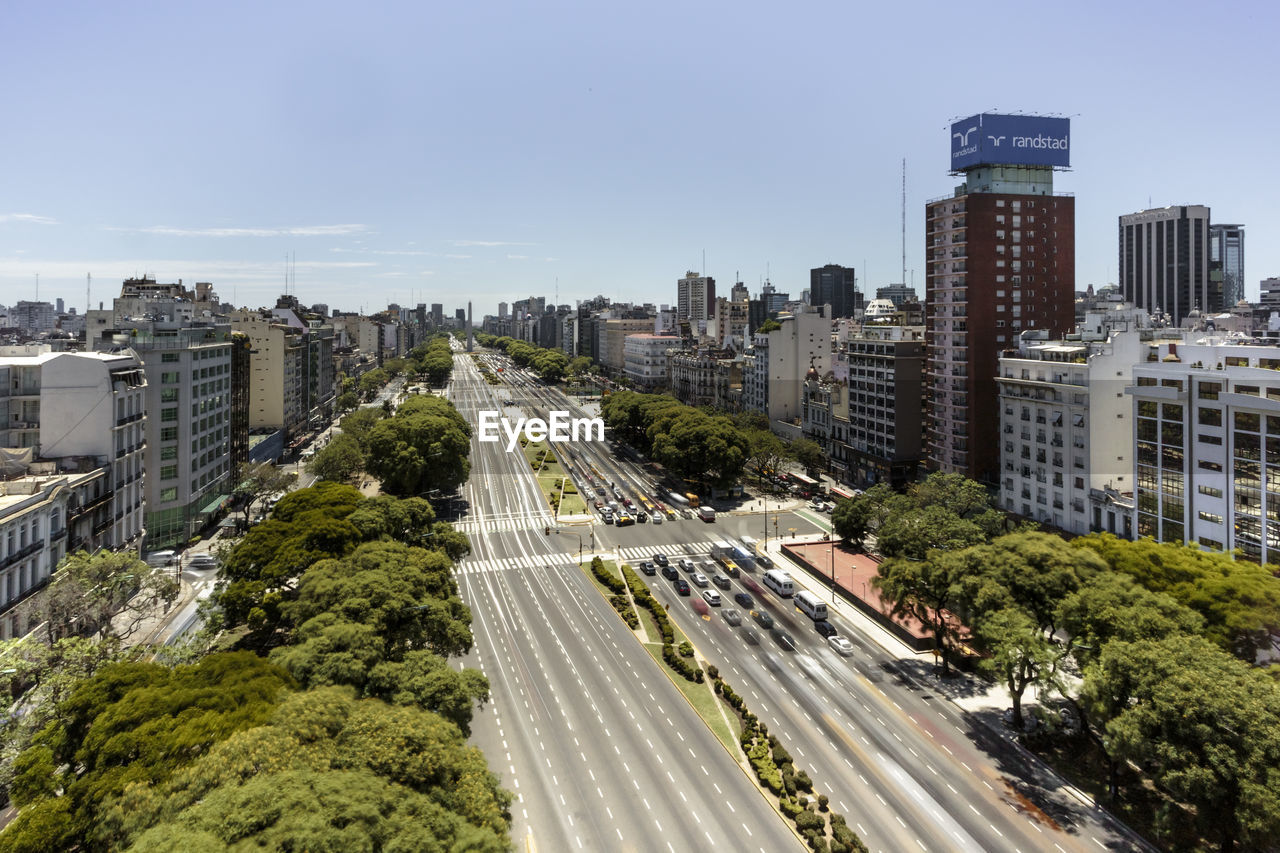 HIGH ANGLE VIEW OF CITY STREET AND TREES