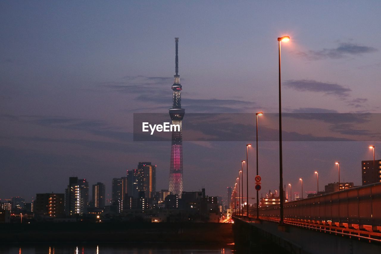 Tokyo sky tree with cityscape against sky at dusk