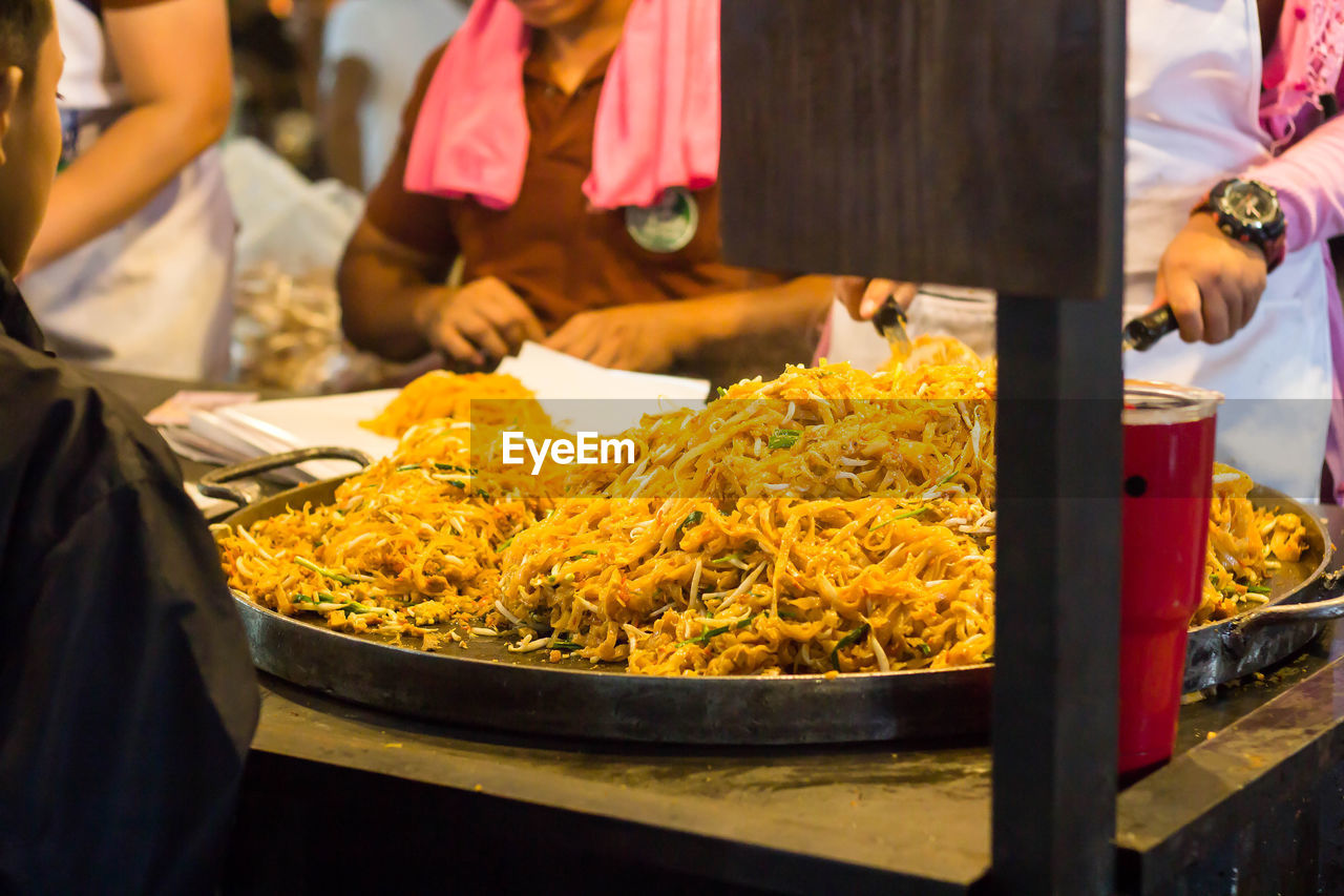 People for sale at market stall