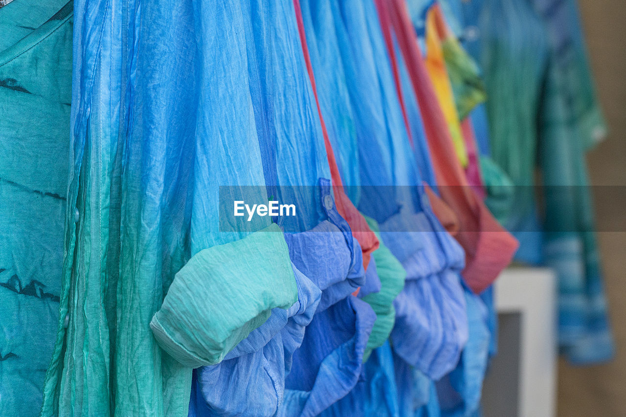 Close-up of multi colored clothing hanging at market stall
