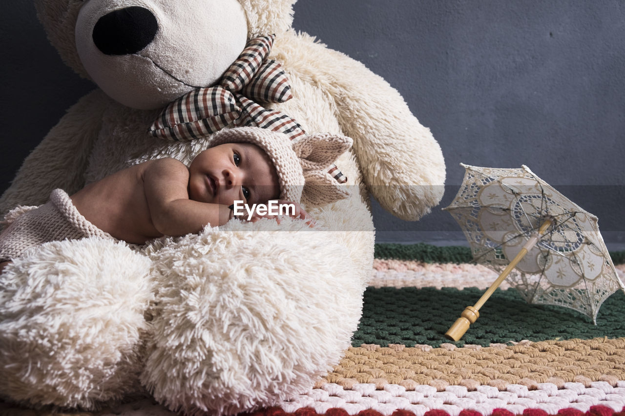 Boy sleeping with stuffed toy at home