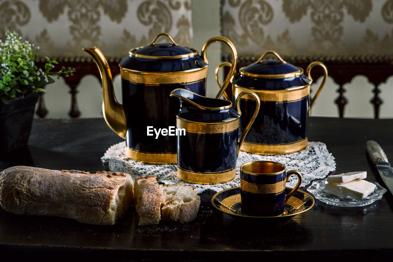 Tea kettles and breads on table