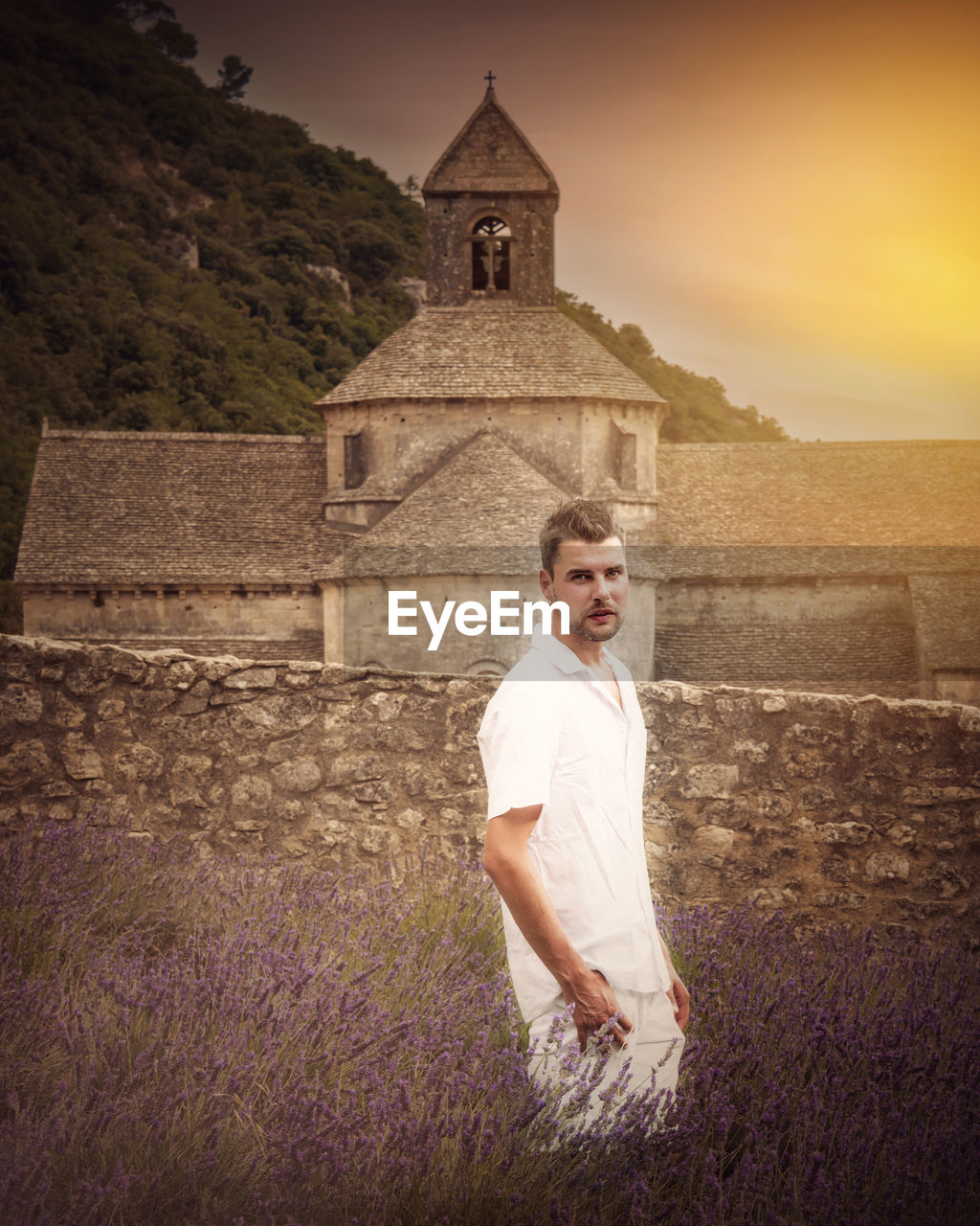 Portrait of man standing amidst lavender against abbaye de senanque