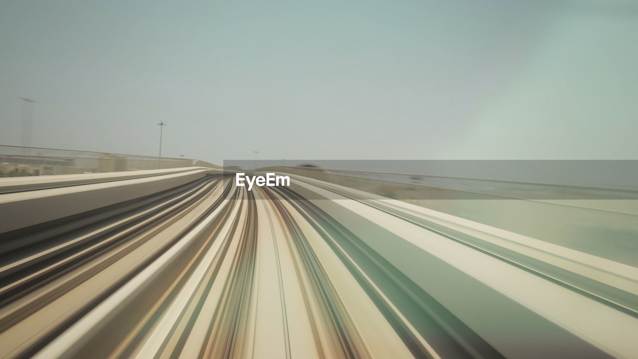 high angle view of light trails on road against clear sky