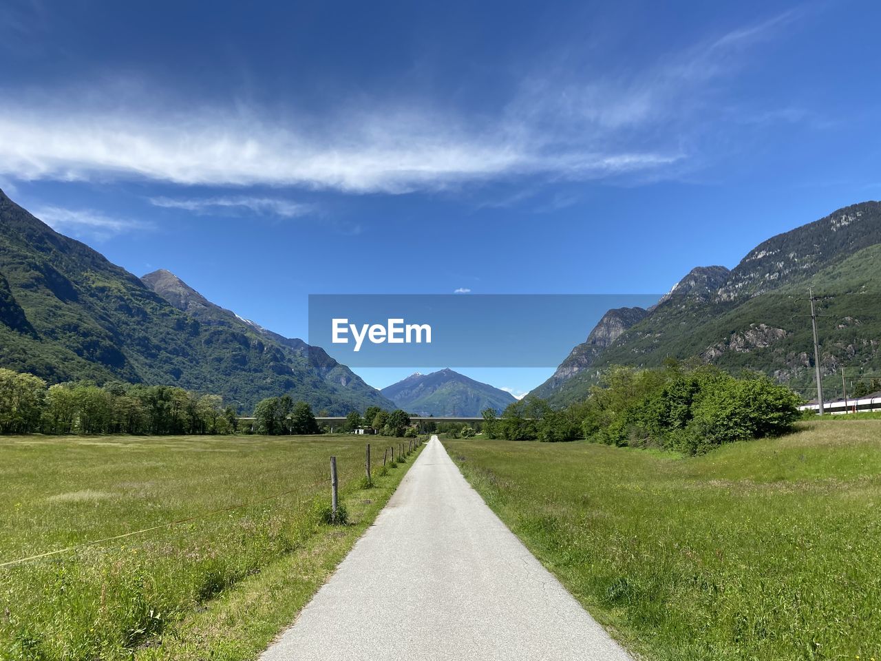 Road leading towards mountains against sky