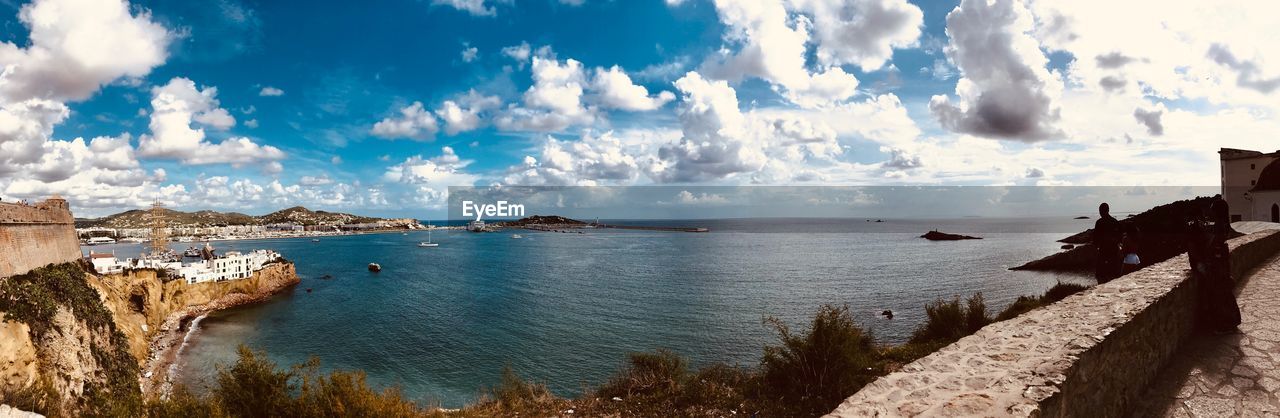 Panoramic view of bay against sky