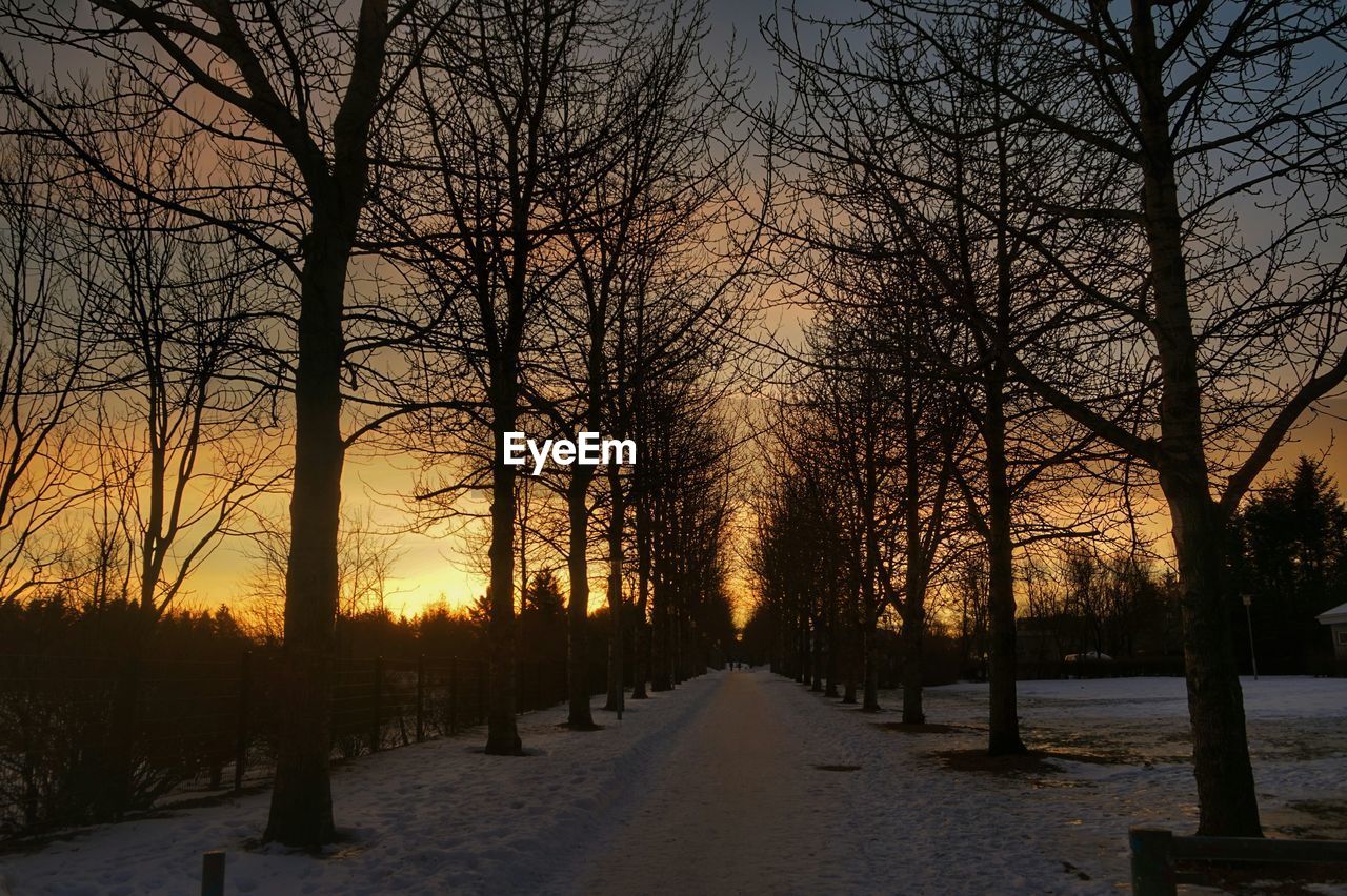 Snow covered road at sunset