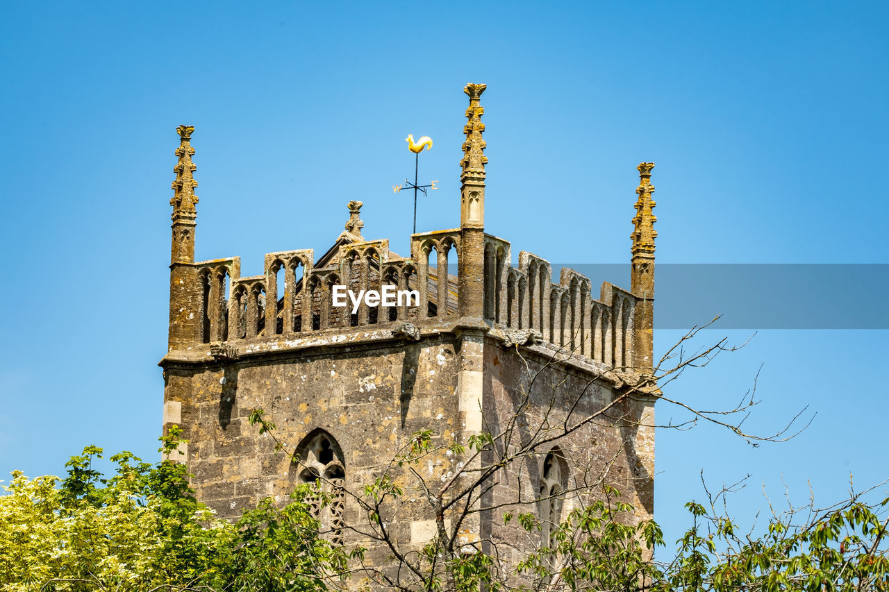 Low angle view of historical church building against clear blue sky