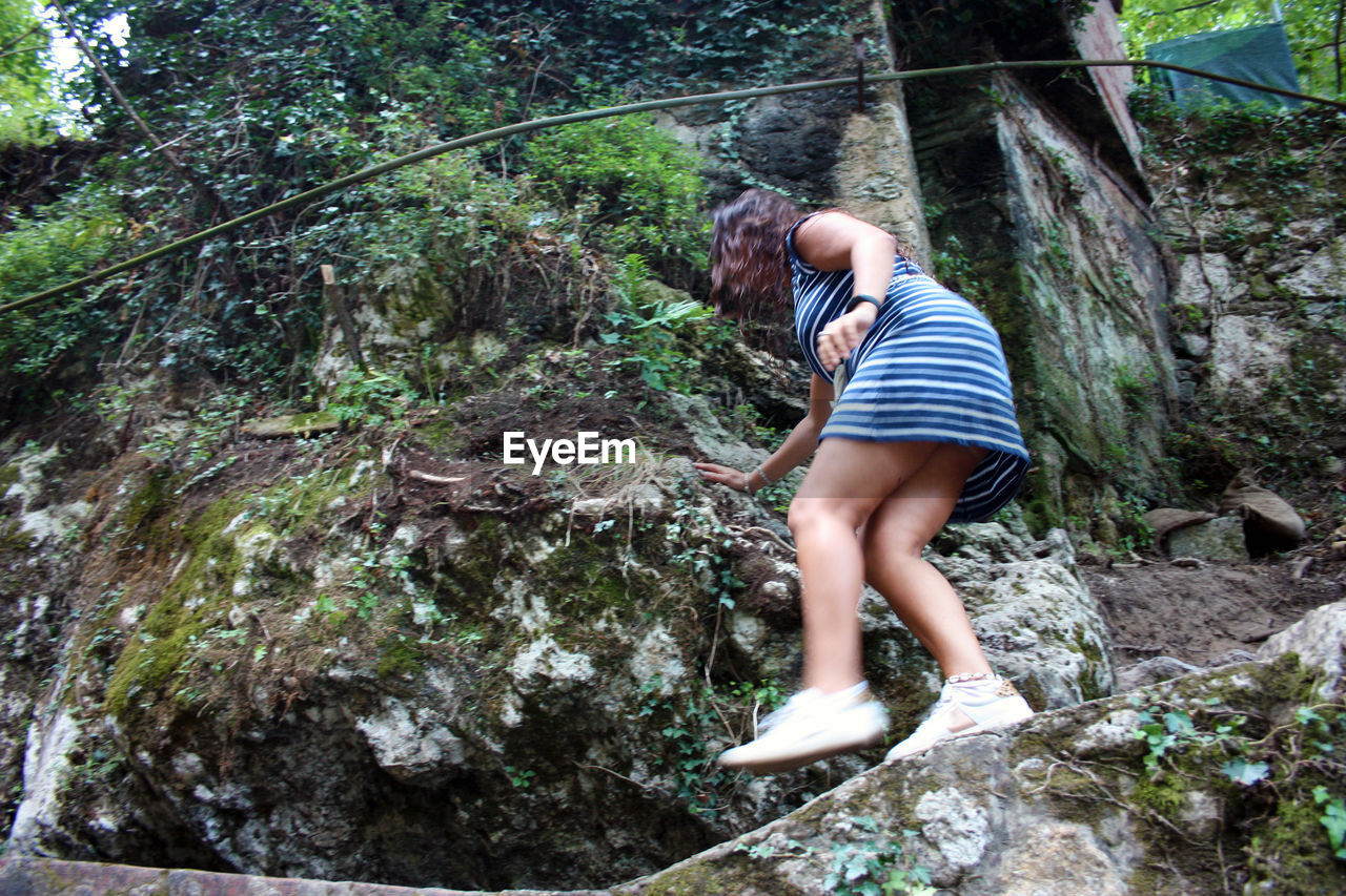 FULL LENGTH OF MAN LYING ON ROCK