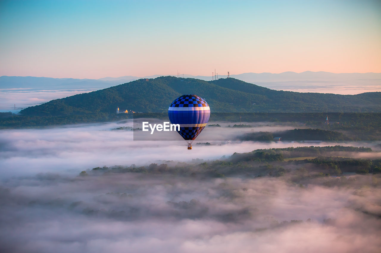 View of hot air balloon above clouds