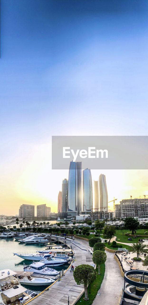 Panoramic view of city buildings against sky during sunset