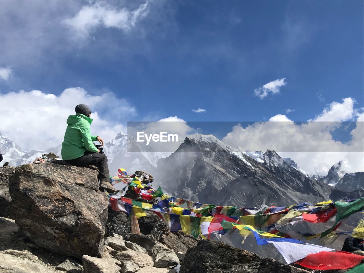 PEOPLE ON ROCK AGAINST SKY