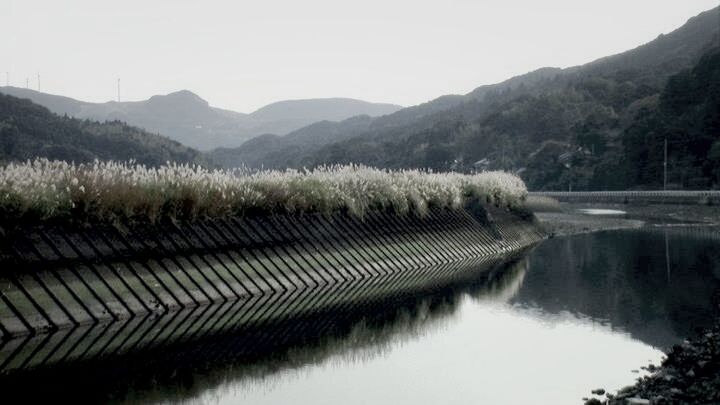 SCENIC VIEW OF LAKE WITH MOUNTAINS IN BACKGROUND