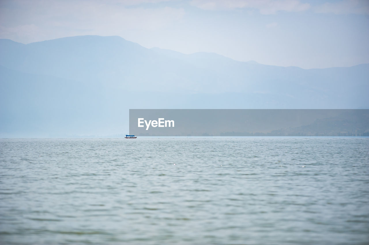 boat sailing on sea against sky