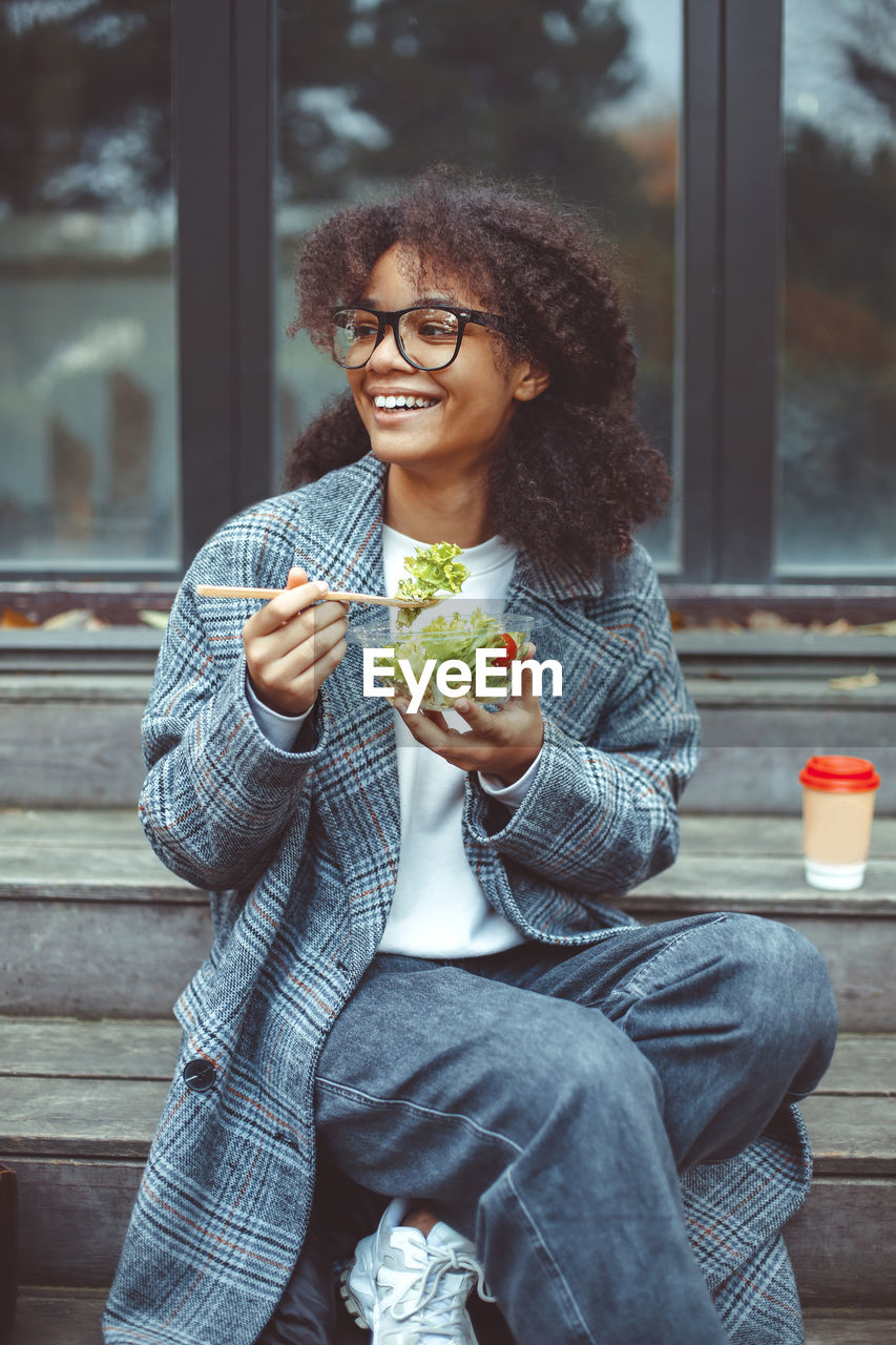 Smiling woman having salad