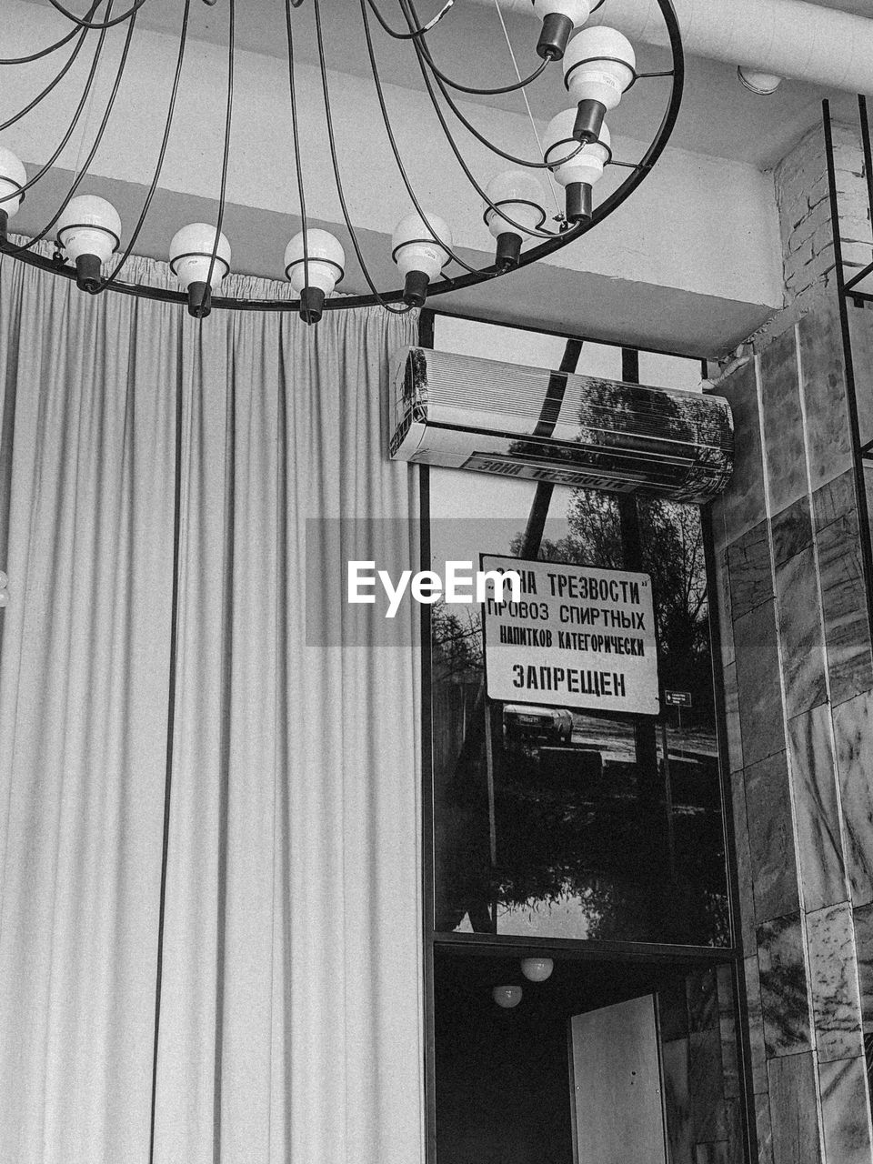 LOW ANGLE VIEW OF INFORMATION SIGN HANGING ON CEILING