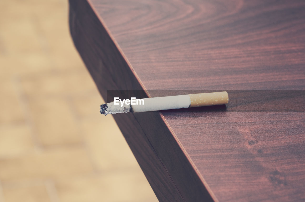 Close-up of cigarette butt on table