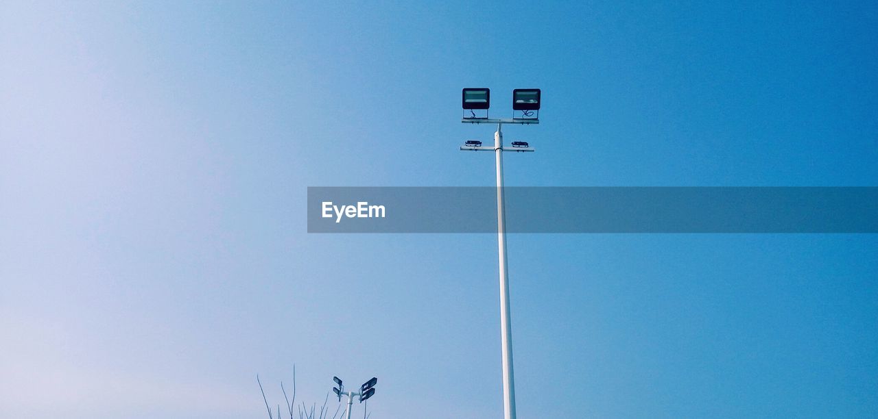 LOW ANGLE VIEW OF TELEPHONE POLE AGAINST BLUE SKY