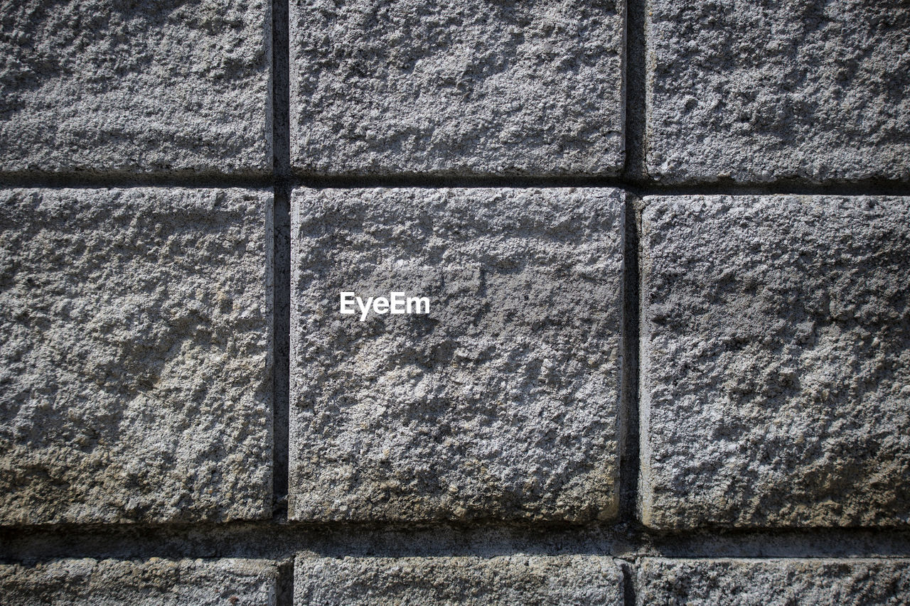 Close up of light gray squares that compose a weather-proof wall