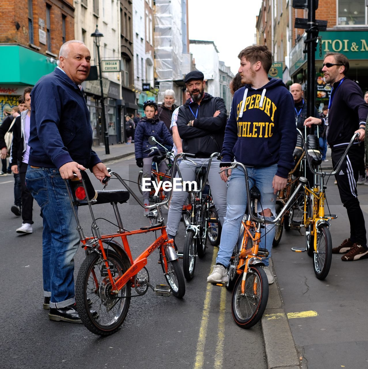 MEN IN BICYCLE ON CITY