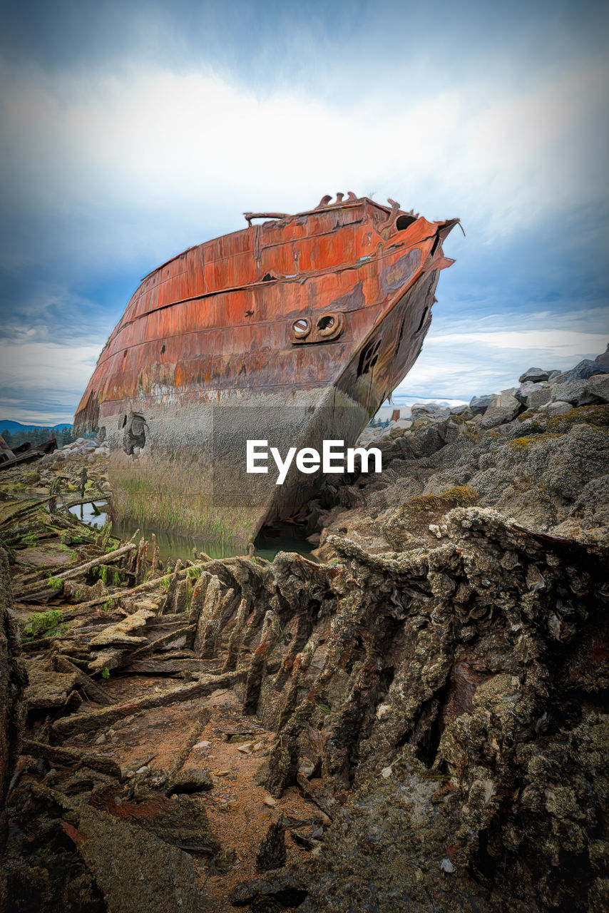 ABANDONED BOAT ON SHORE