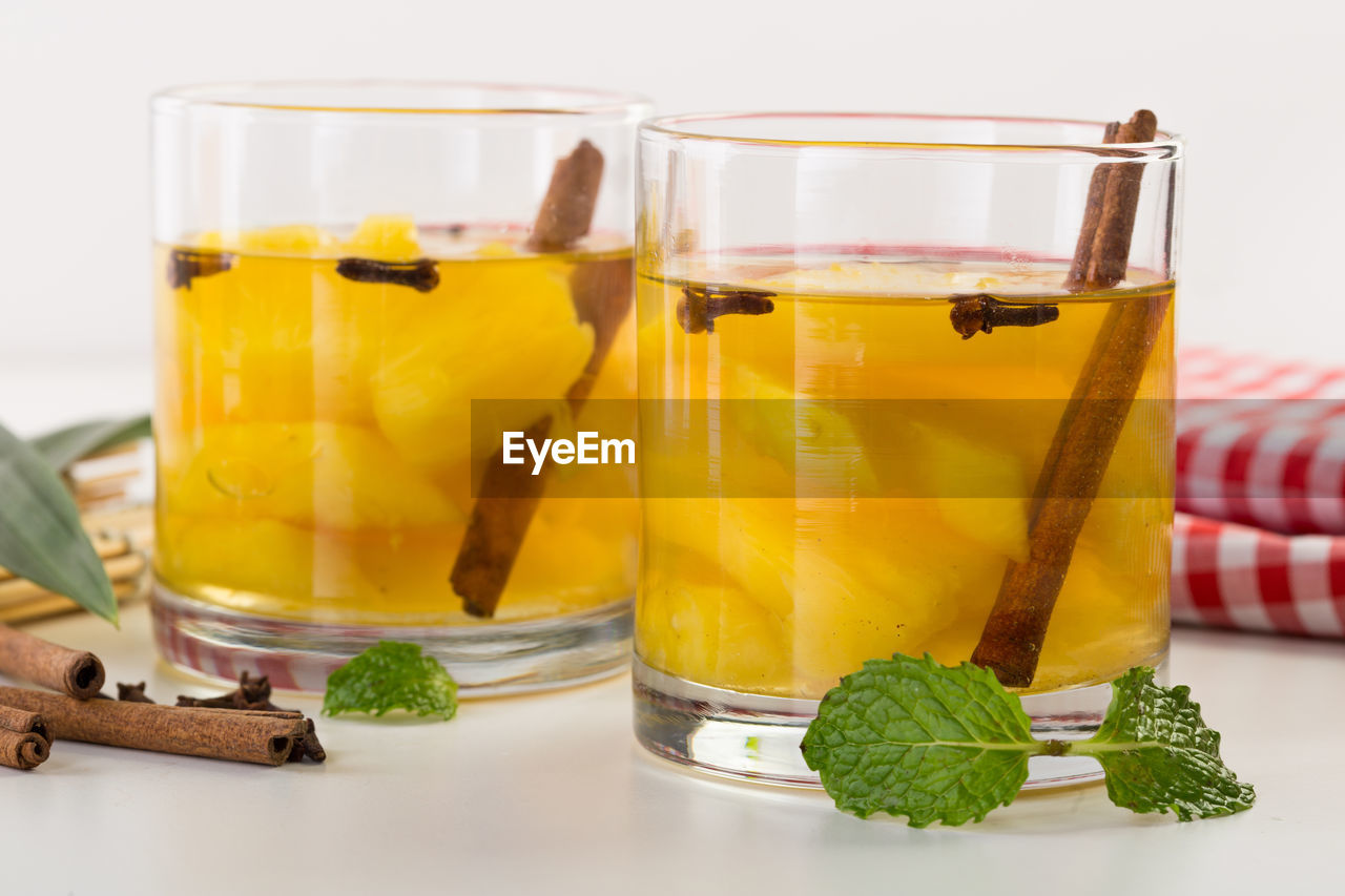 Close-up of drink in glasses on white table