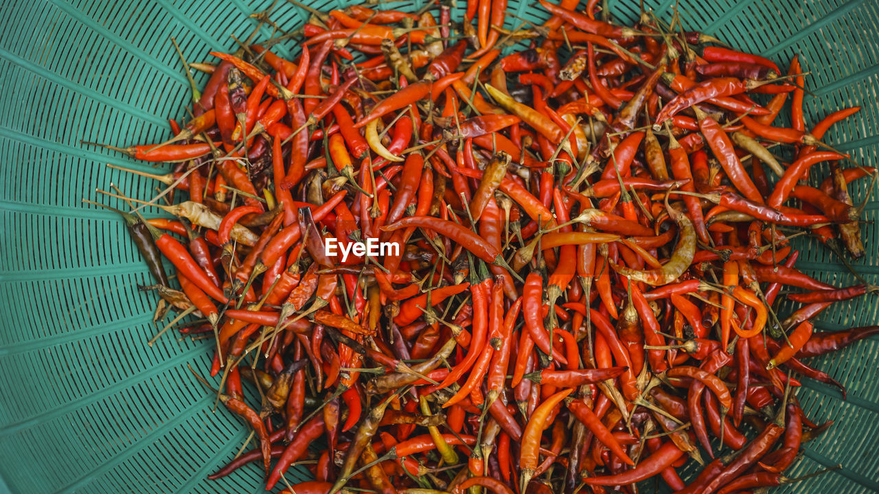 High angle view of red chili peppers in basket