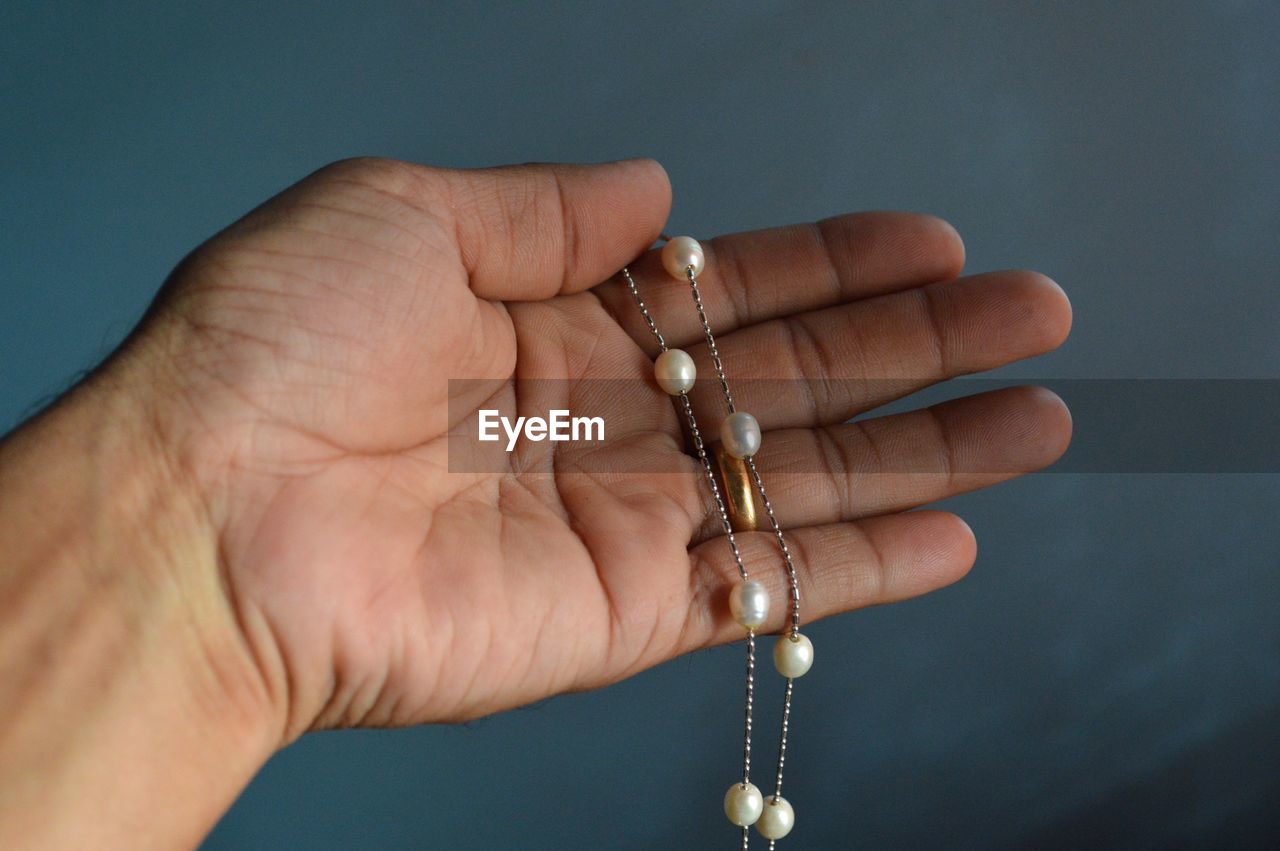 Close-up of hand holding jewelry