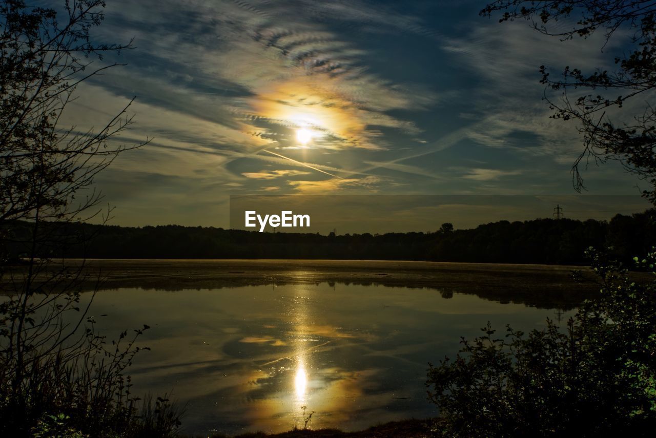 SCENIC VIEW OF SUNSET OVER LAKE