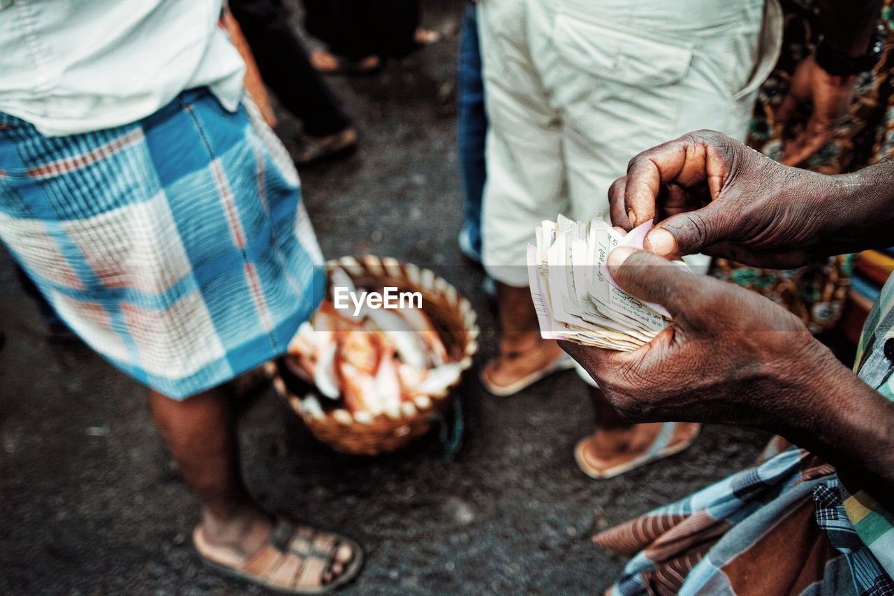 Low section of vendor holding currency