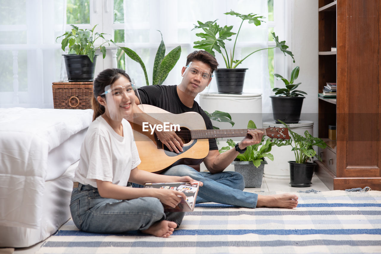 FRIENDS SITTING ON POTTED PLANT