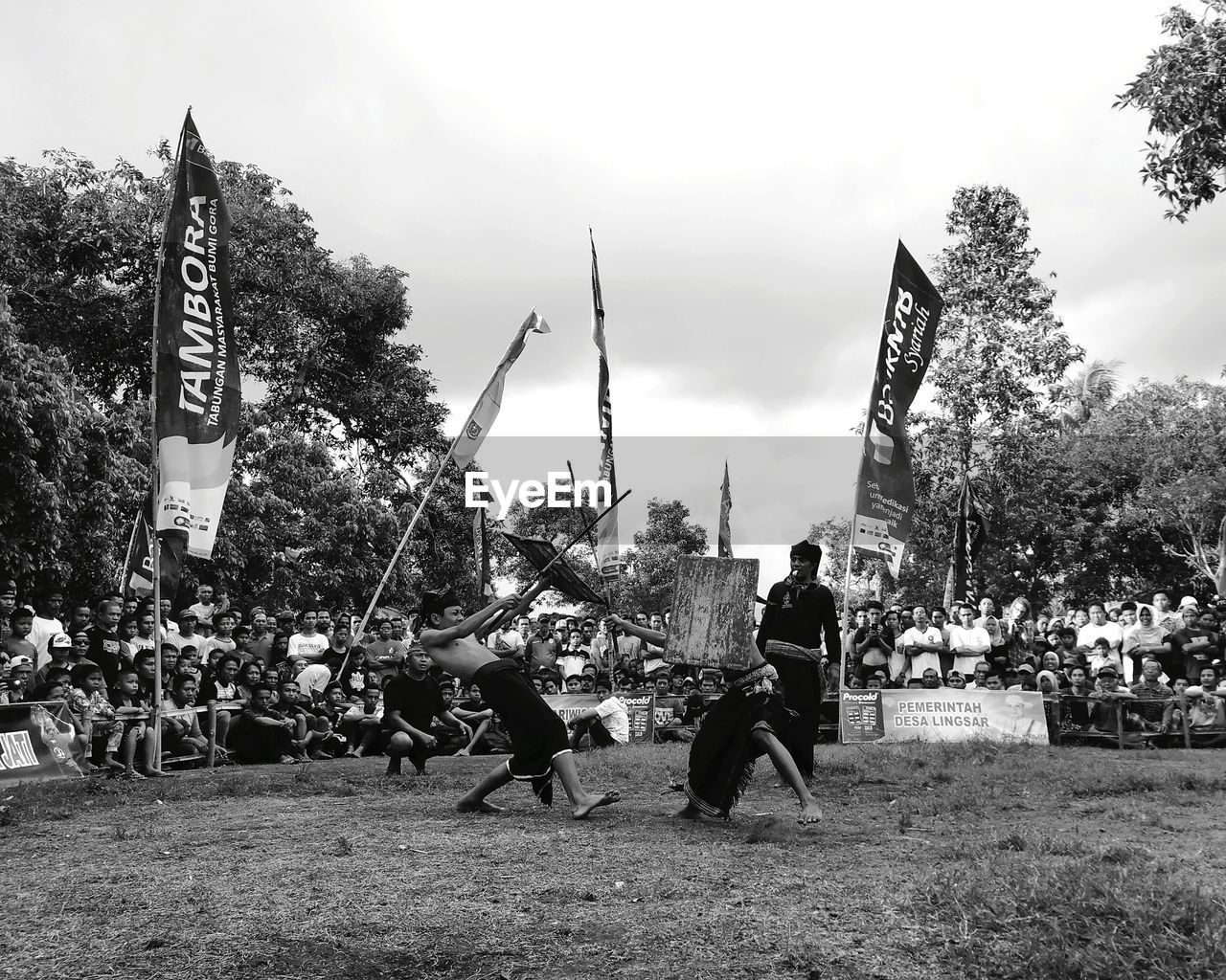 GROUP OF PEOPLE ON PLANTS AGAINST TREES