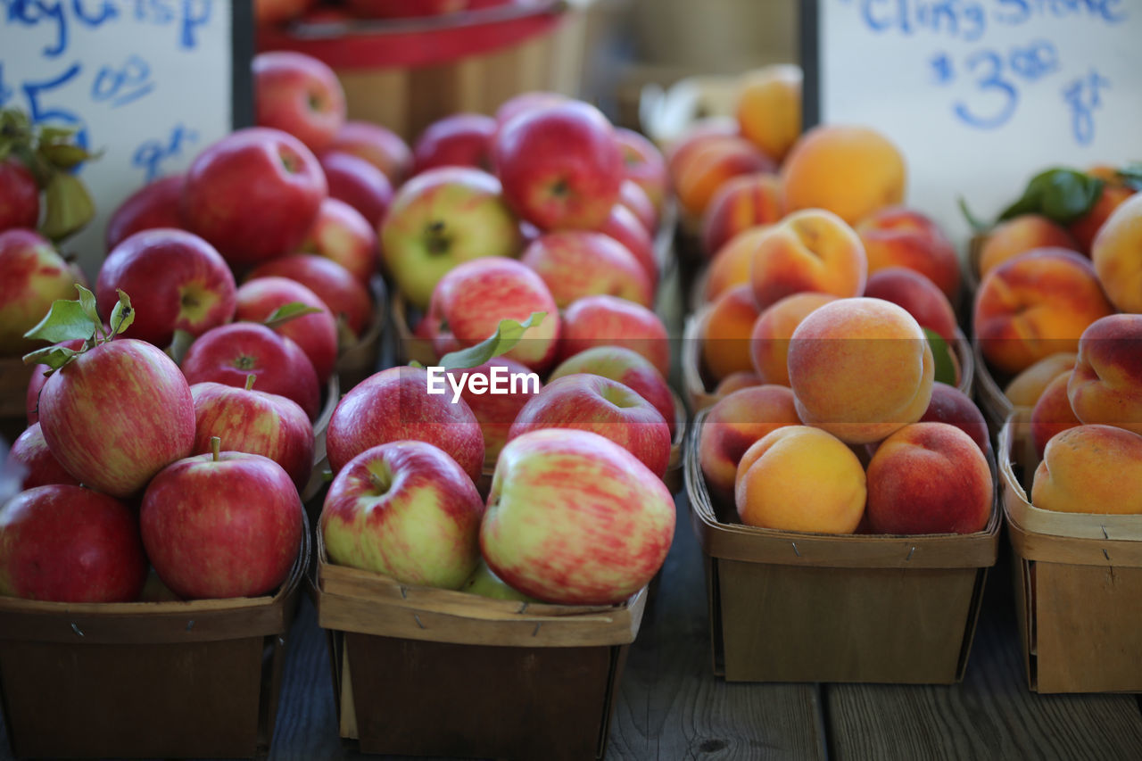 Apples and peaches for sale at an autumn farmer's market