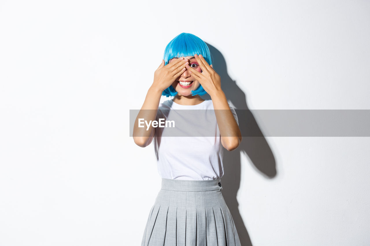 Woman standing against white background