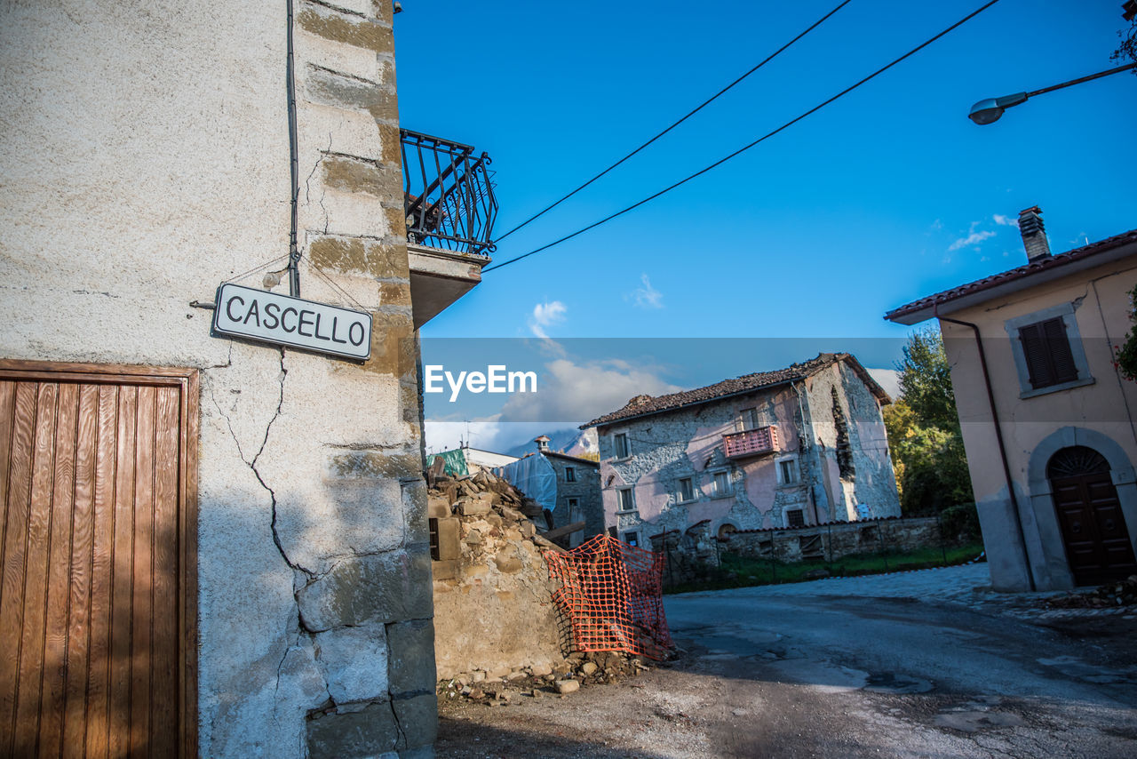 STREET BY BUILDING AGAINST SKY