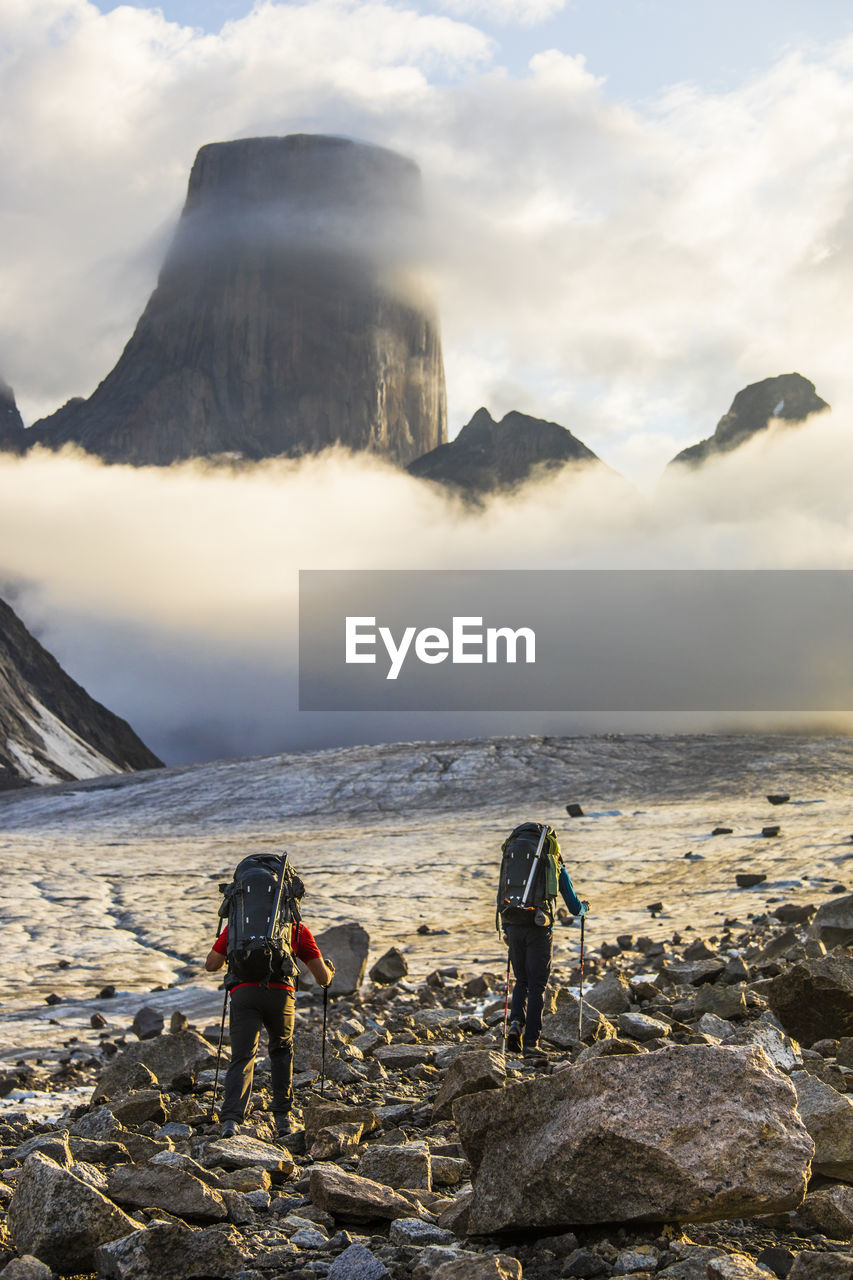 Two climbers en route to climb mount asgard, baffin island.
