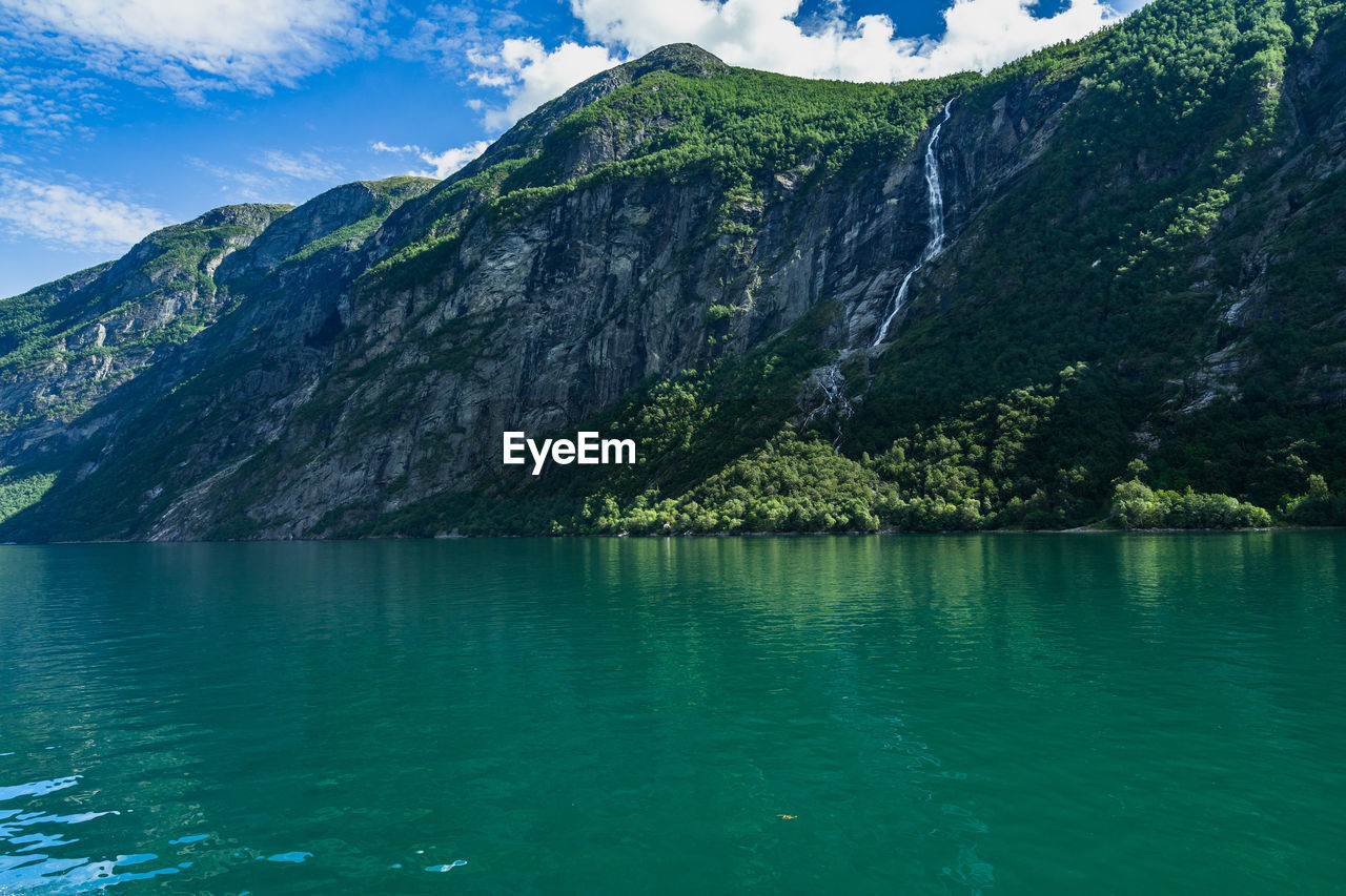 Geirangerfjord has impressive natural landscape with waterfalls overlooking the fjord, norway