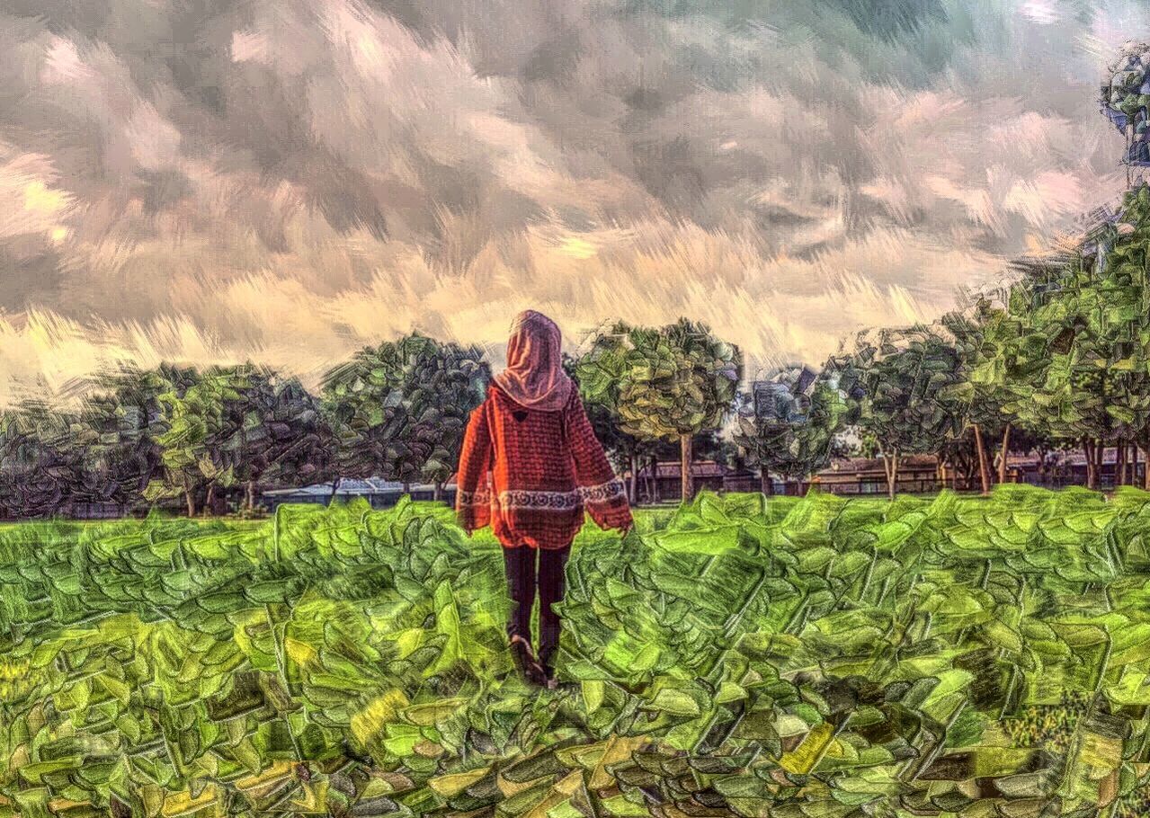 YOUNG WOMAN STANDING ON GRASS