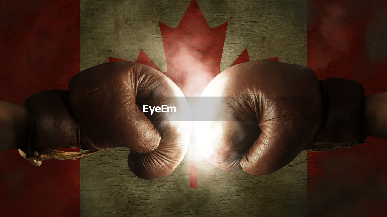 Close-up of boxing gloves in front of canadian flag