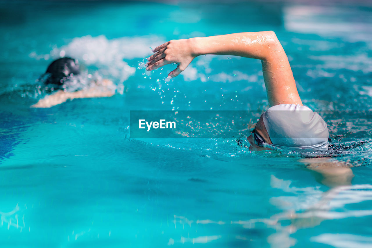 Women swimming in pool during competition