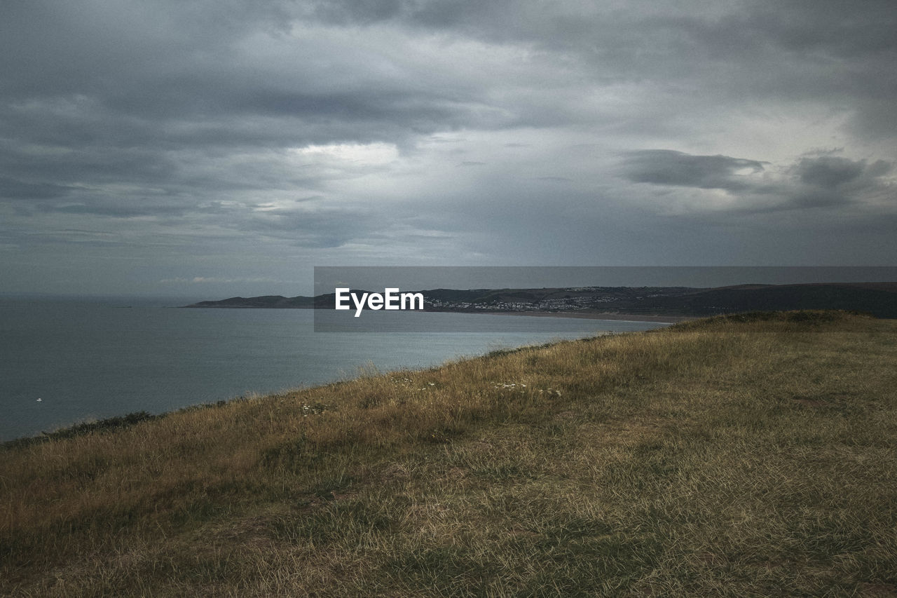 SCENIC VIEW OF SEA SHORE AGAINST SKY