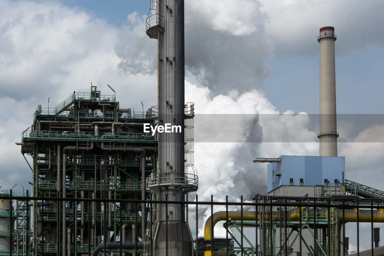 Factory against cloudy sky