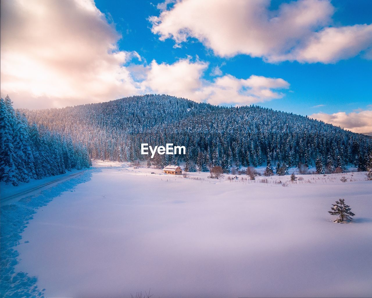 Snow covered landscape against sky