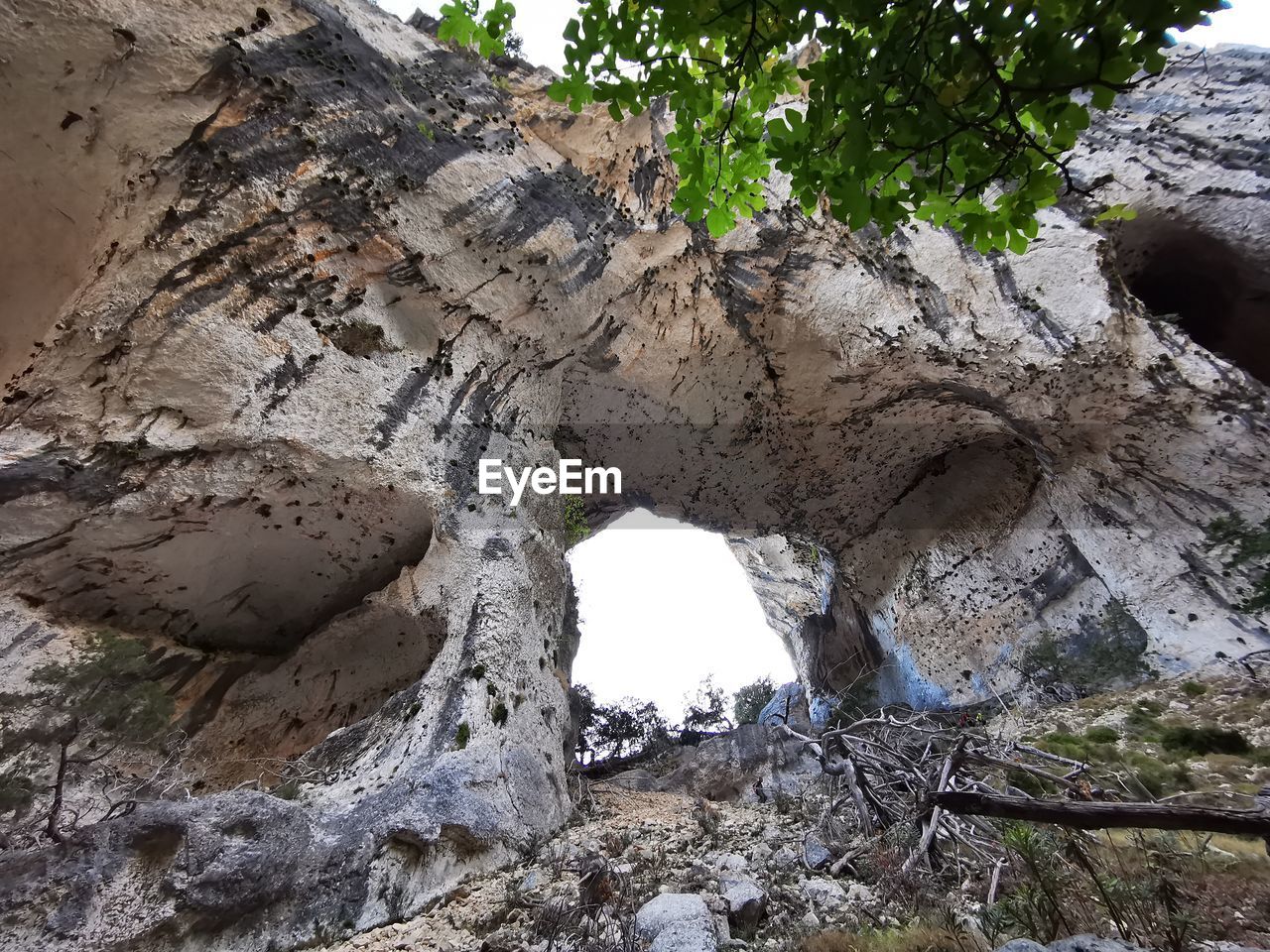 LOW ANGLE VIEW OF ROCK FORMATION ON CAVE