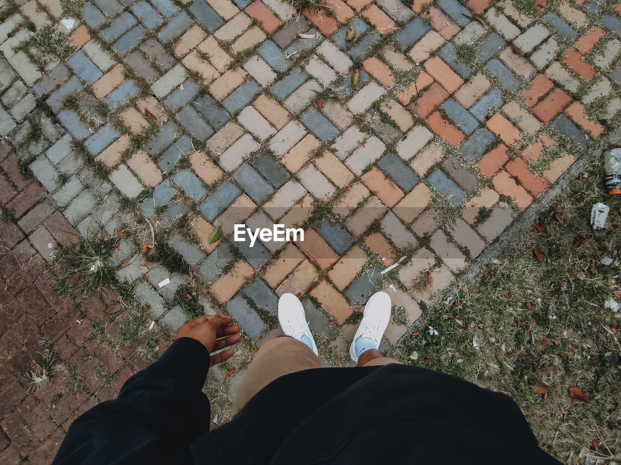 low section of person standing on footpath