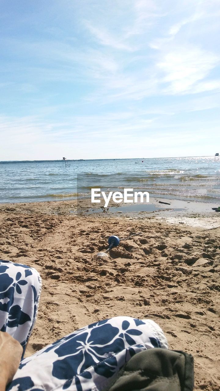 LOW SECTION OF PERSON ON BEACH