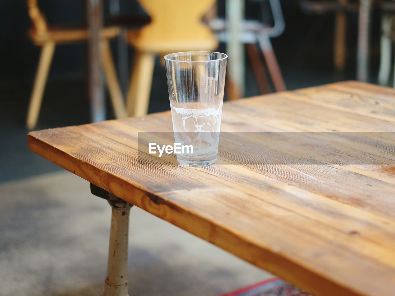 Empty beer glass on table