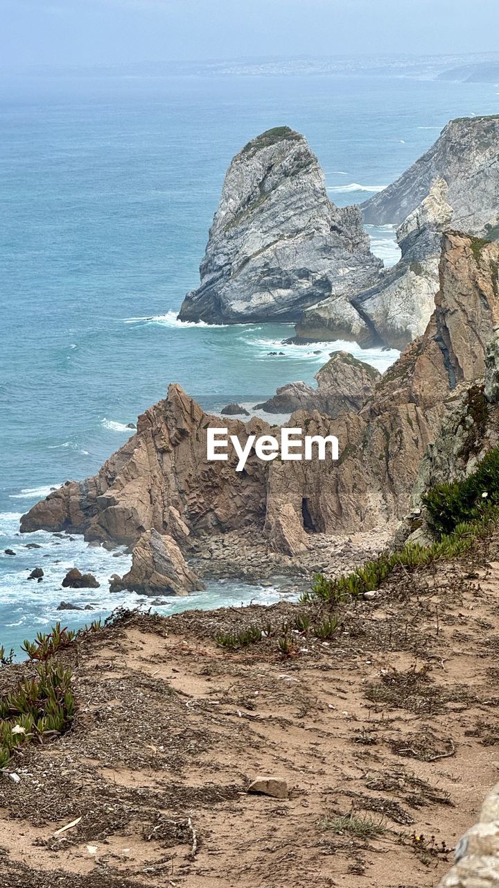 sea, water, land, scenics - nature, beach, beauty in nature, rock, coast, shore, cliff, nature, sky, ocean, tranquility, tranquil scene, horizon over water, rock formation, no people, day, geology, horizon, terrain, body of water, travel destinations, coastline, outdoors, bay, travel, environment, cove, landscape, non-urban scene, idyllic, blue, mountain