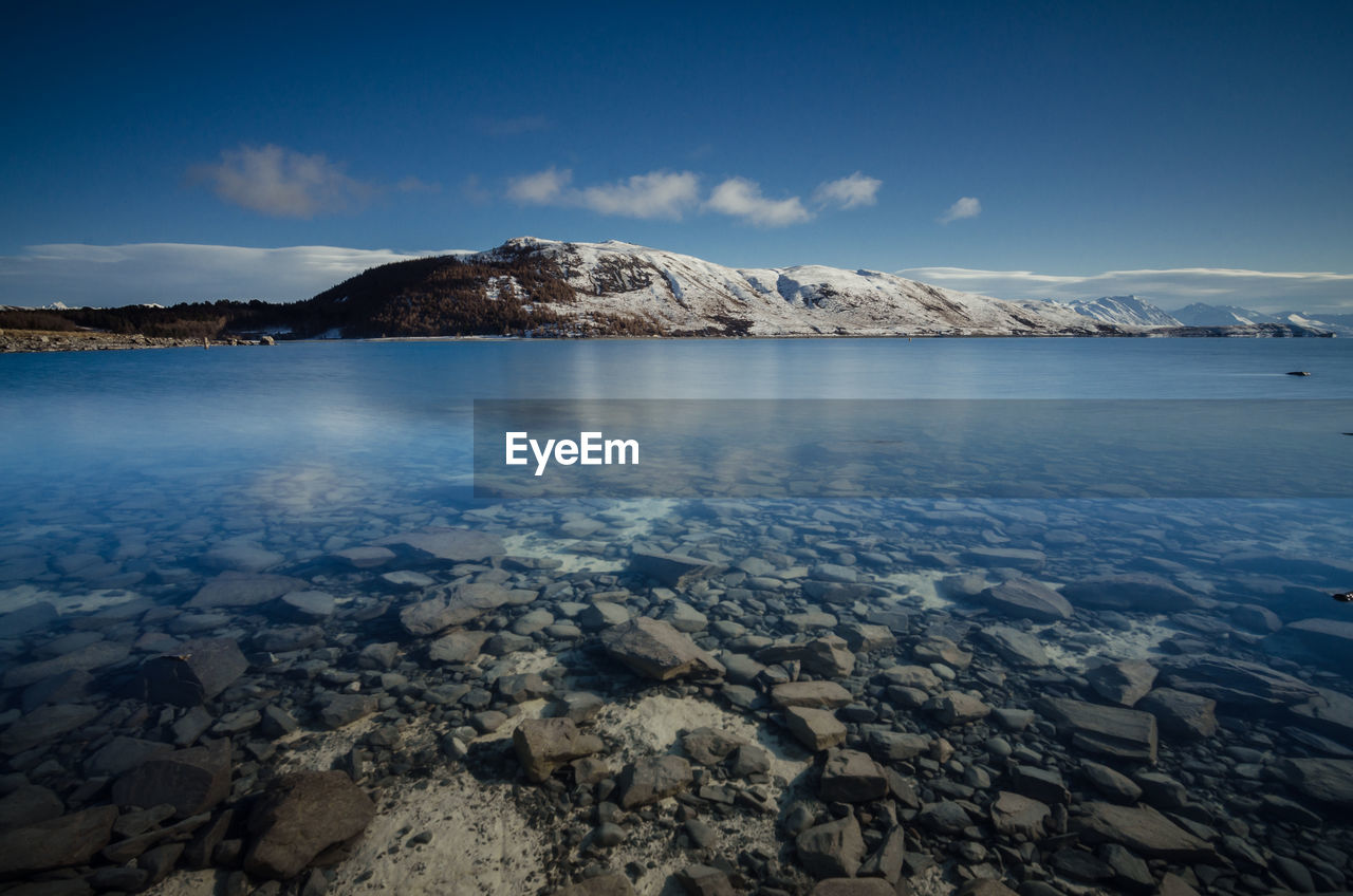 Scenic view of lake against sky during winter