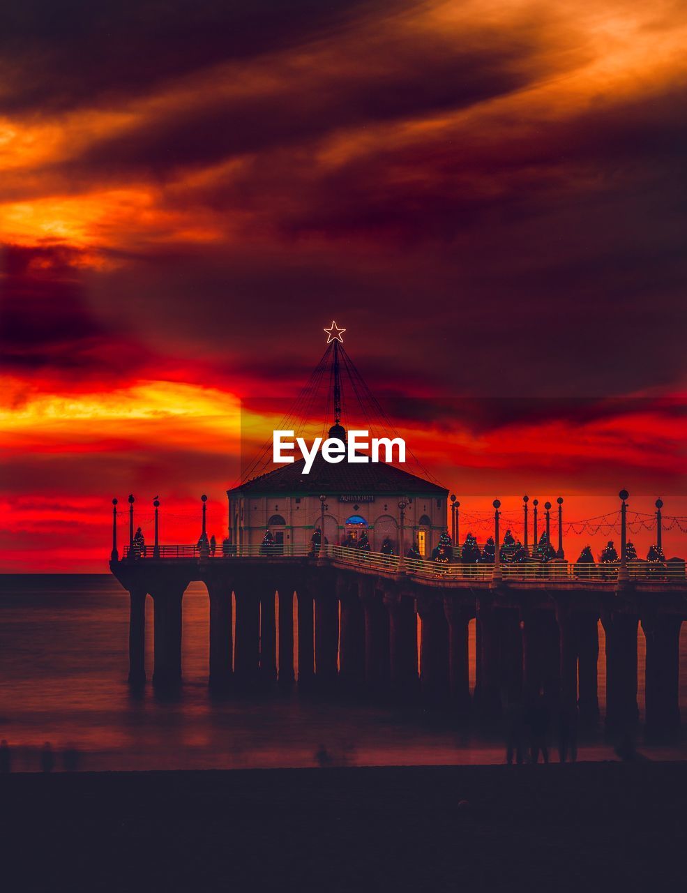 View of building against cloudy sky during sunset